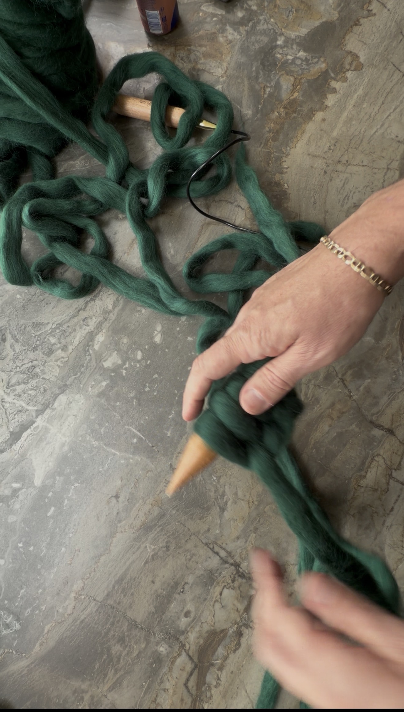 The long-tail cast-on in progress on a giant needle