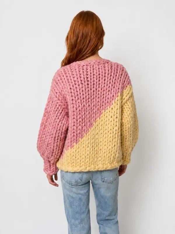 The back of the Dual cardigan: a staircase of giant stitches where the pink and yellow meet.
