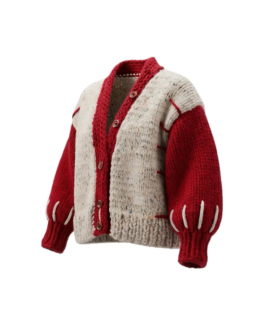 The Sovereign cardigan: cream speckle body with deep red trim and visible red mattress-stitch seams.